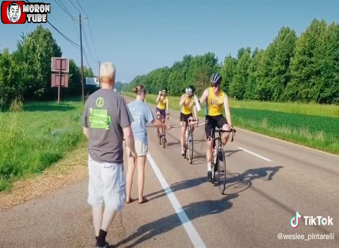 Video :A lady seeks to gather water bottles from bikers using a fishing net (FAIL)